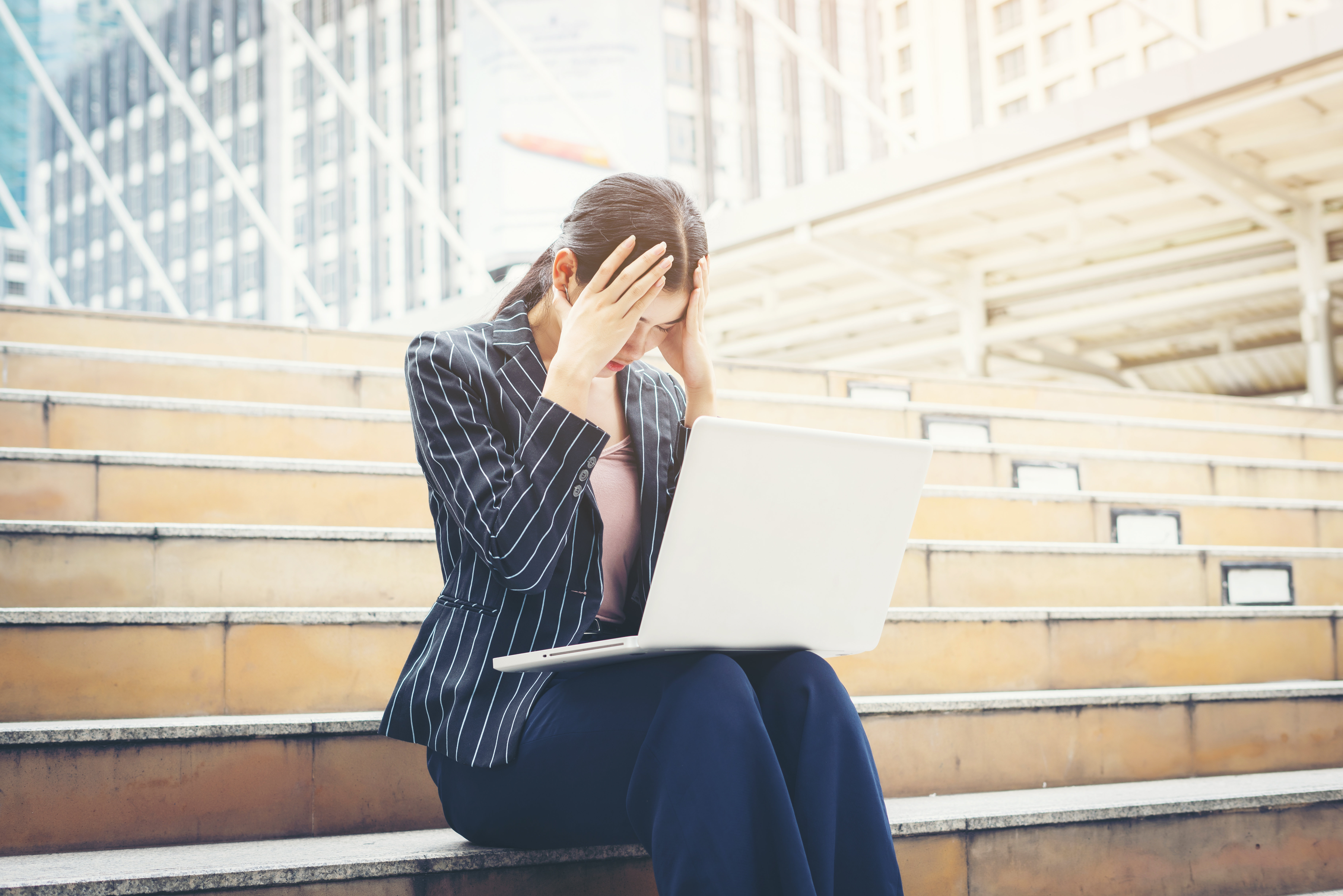 business-woman-stressed-while-using-laptop-sits-steps-business-people-concept.jpg